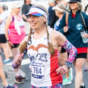 Ann Hegstrom sports her signature red, white and blue look with pigtails during a race at the National Senior Games.
